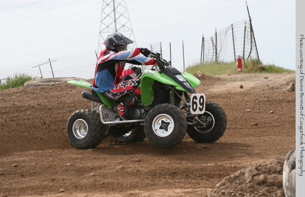 Quad raceer drifting a corner at Prairie City's Off Road Race Course.